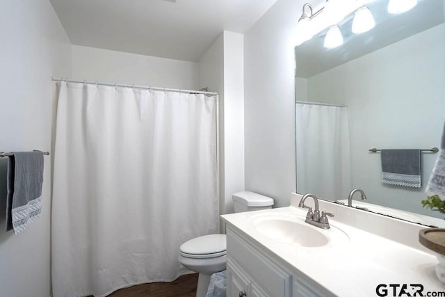 full bathroom with vanity, wood finished floors, and toilet