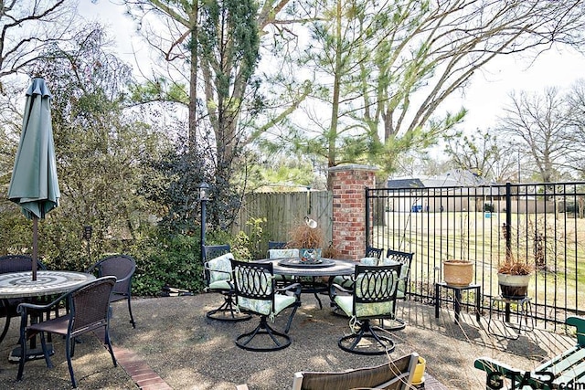 view of patio / terrace with outdoor dining space and fence