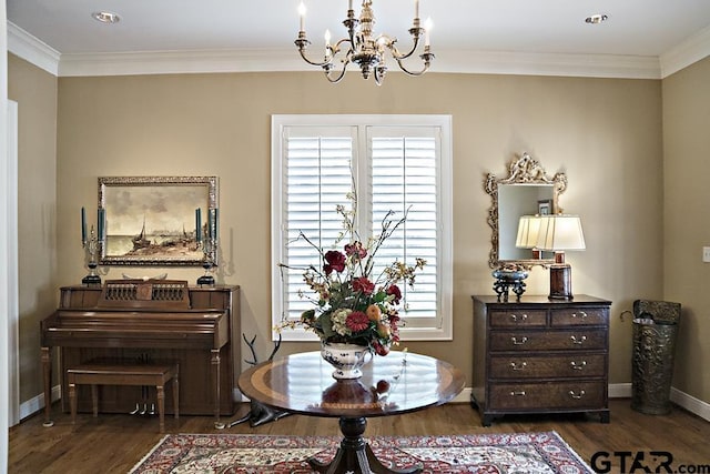 living area with dark wood-style floors, baseboards, a chandelier, and ornamental molding