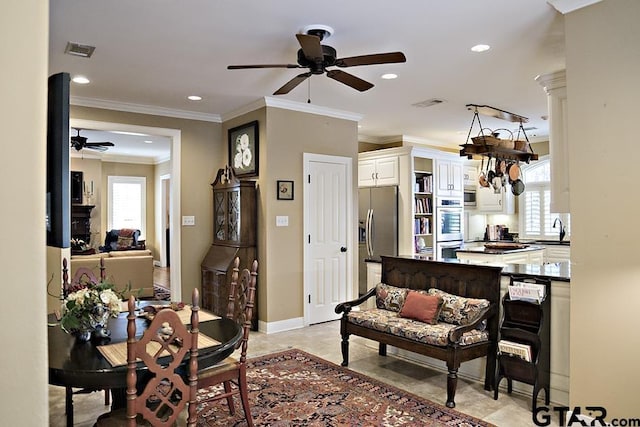 dining area featuring crown molding, a healthy amount of sunlight, and visible vents