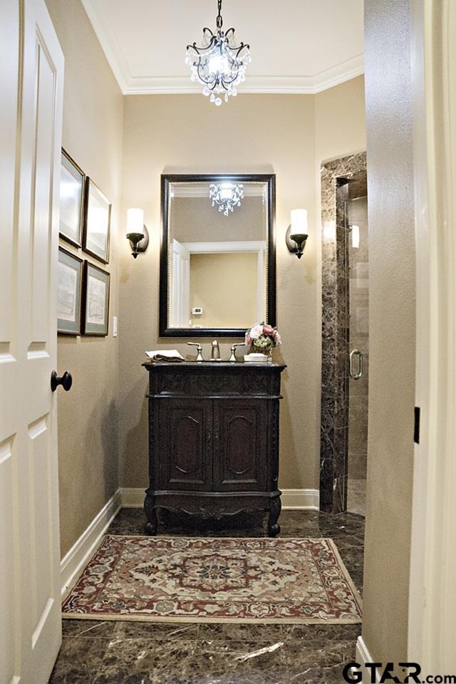 bathroom with vanity, baseboards, and ornamental molding