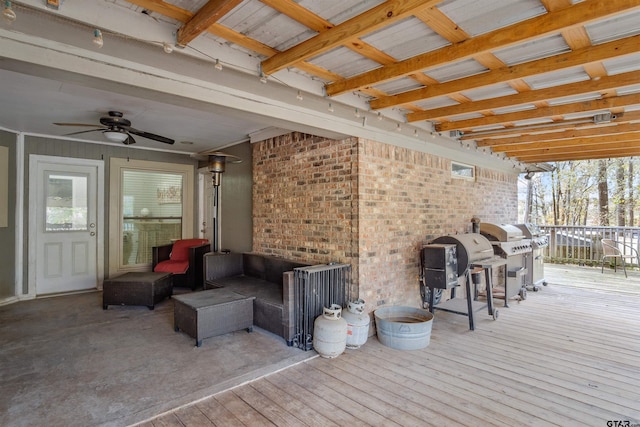 wooden deck with ceiling fan, a grill, and an outdoor hangout area