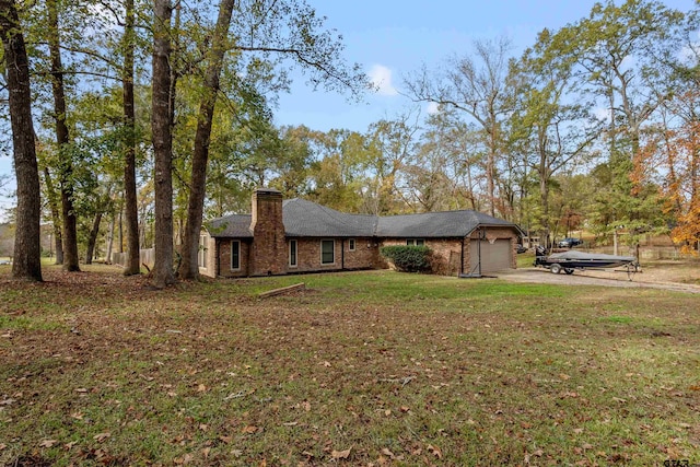 view of side of home with a lawn and a garage