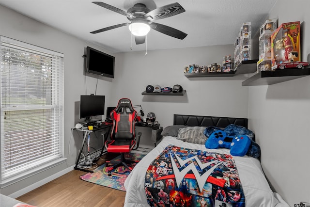 bedroom with ceiling fan and hardwood / wood-style floors