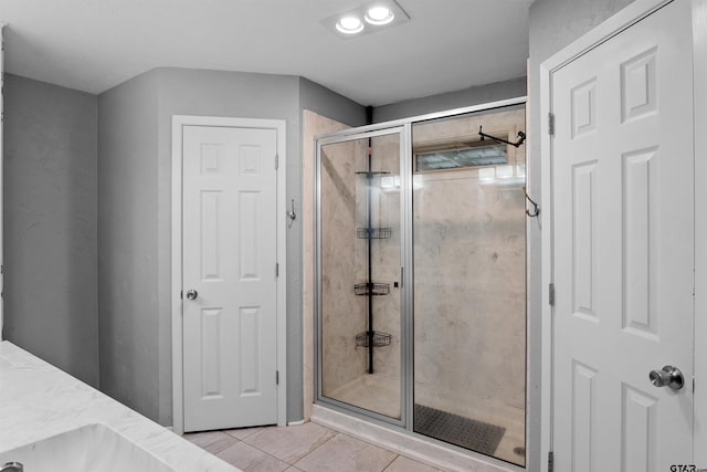 bathroom featuring tile patterned flooring, vanity, and an enclosed shower