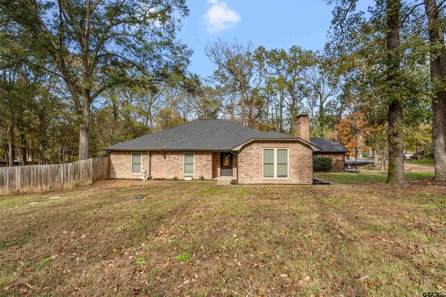 ranch-style home featuring a front yard