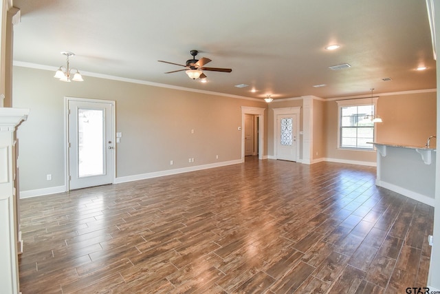 unfurnished living room featuring ornamental molding and ceiling fan with notable chandelier