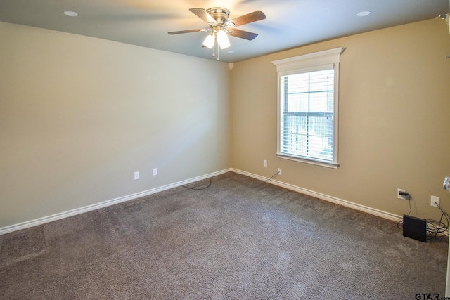 unfurnished room with ceiling fan and carpet