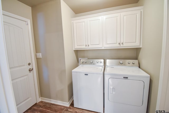 clothes washing area with cabinets and washer and clothes dryer