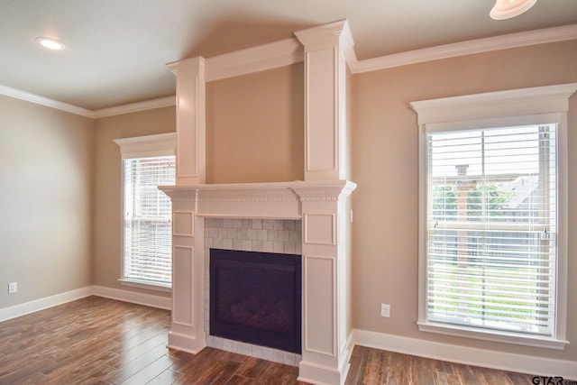 unfurnished living room with dark hardwood / wood-style flooring, crown molding, and a tile fireplace