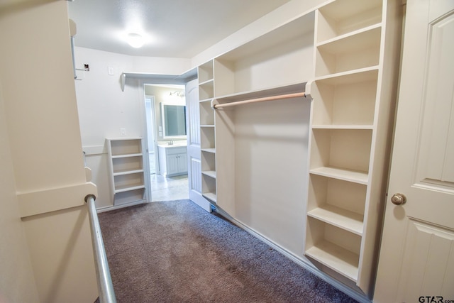 spacious closet with dark carpet