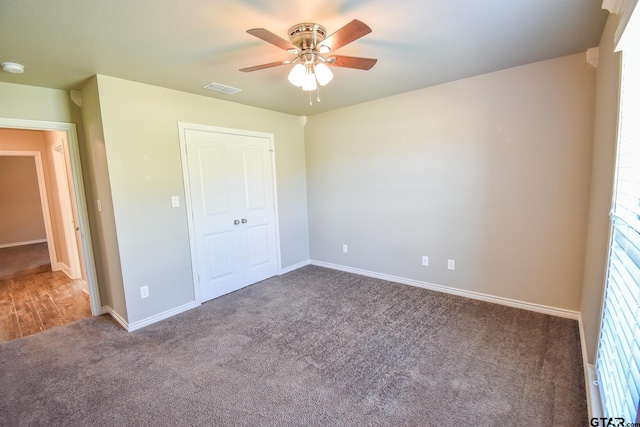 unfurnished bedroom featuring a closet, ceiling fan, and carpet flooring