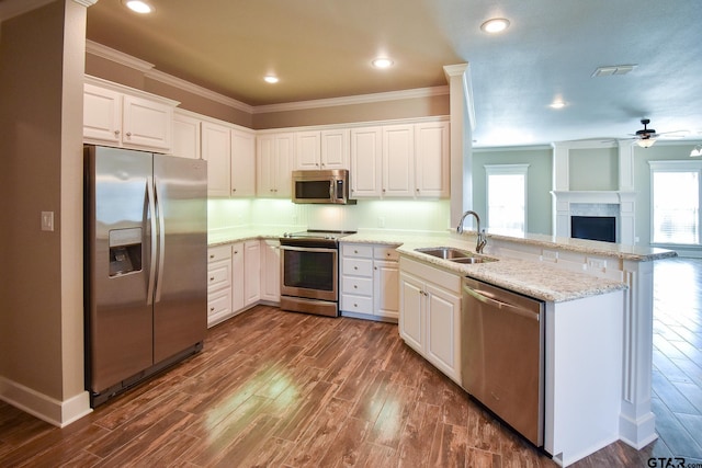 kitchen featuring white cabinetry, stainless steel appliances, kitchen peninsula, and sink