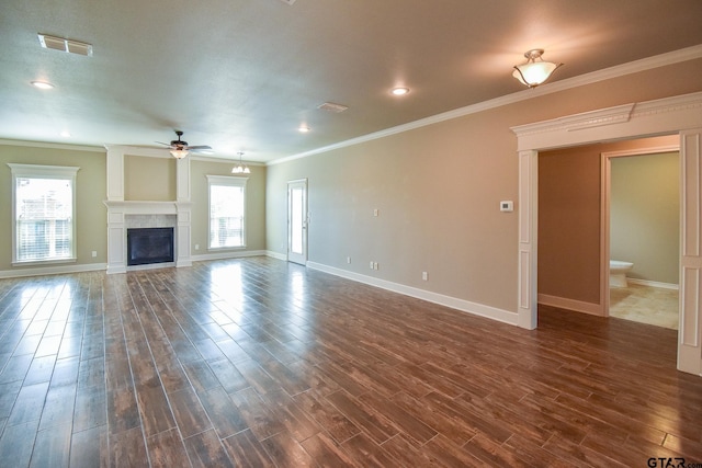 unfurnished living room featuring ceiling fan, crown molding, and a healthy amount of sunlight