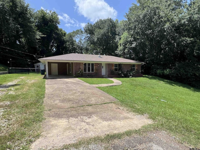 117 Harvey St, Rusk, TX 75785 - ranch-style house featuring an attached carport, driveway, a front yard, and brick siding