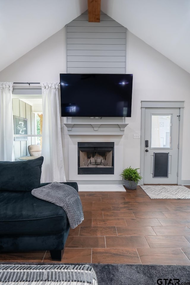 15348 C R 169, Tyler, TX 75703 - living area with wood finished floors, a fireplace with raised hearth, and high vaulted ceiling