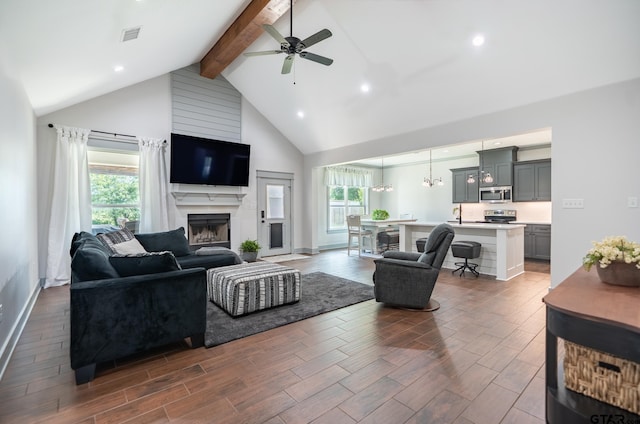 15348 C R 169, Tyler, TX 75703 - living area with beam ceiling, high vaulted ceiling, ceiling fan, dark wood-type flooring, and a high end fireplace