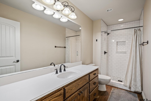 bathroom with toilet, vanity, wood-type flooring, and a shower with shower curtain