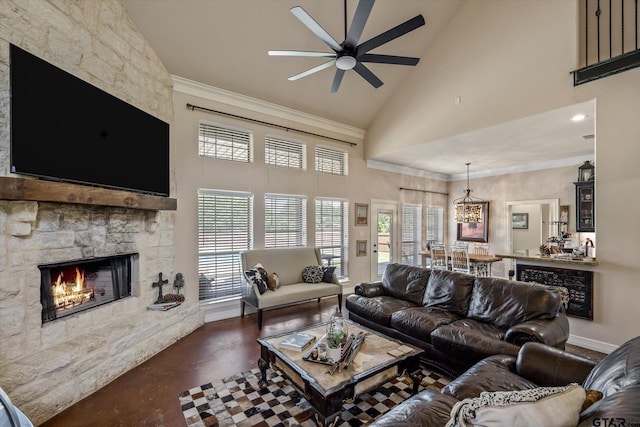 living room featuring a stone fireplace, high vaulted ceiling, ceiling fan with notable chandelier, and crown molding