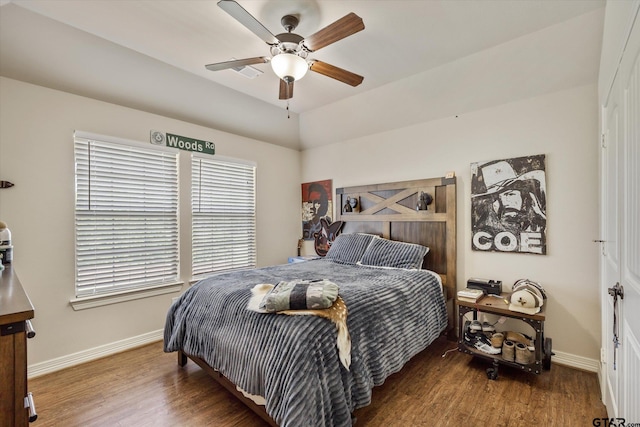 bedroom with dark hardwood / wood-style flooring and ceiling fan