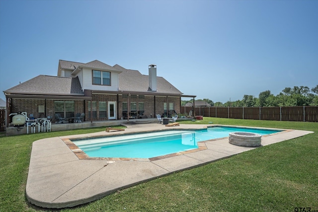 view of swimming pool with a lawn, a patio, and a jacuzzi