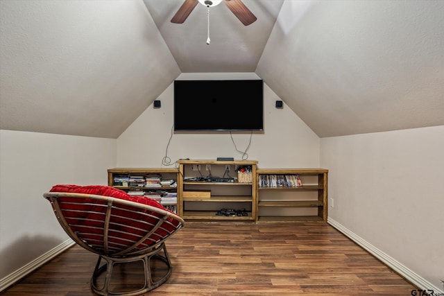 living area with lofted ceiling, ceiling fan, and wood-type flooring