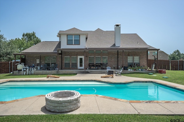 view of pool with a patio area, a lawn, and an outdoor fire pit