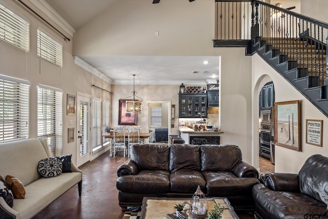 living room with high vaulted ceiling, a chandelier, and crown molding