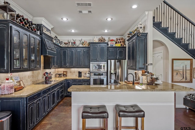 kitchen featuring crown molding, stainless steel appliances, custom range hood, decorative backsplash, and sink