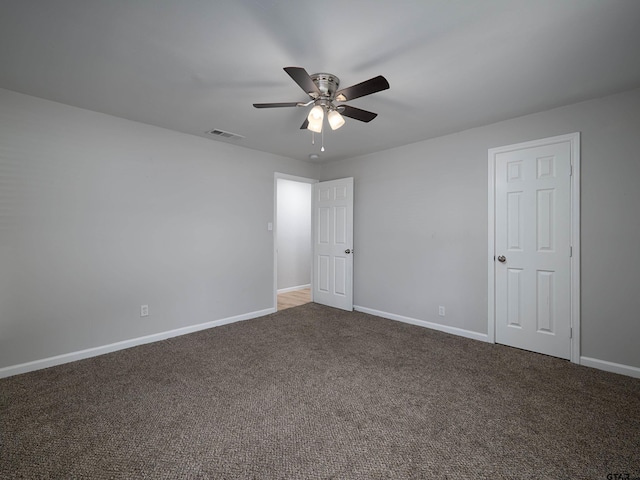 spare room with carpet flooring, visible vents, baseboards, and ceiling fan
