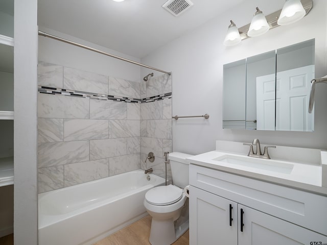 full bath featuring bathtub / shower combination, vanity, visible vents, toilet, and wood finished floors