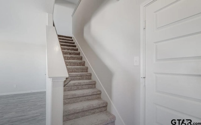 208 Parker Oaks Dr, Chandler, TX 75758 - stairs with baseboards and wood finished floors