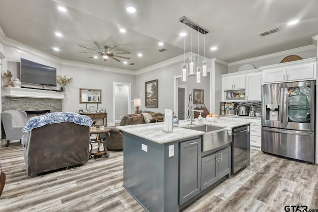 113 Stuart St, Arp, TX 75750 - kitchen with open floor plan, stainless steel appliances, gray cabinetry, white cabinetry, and ornamental molding
