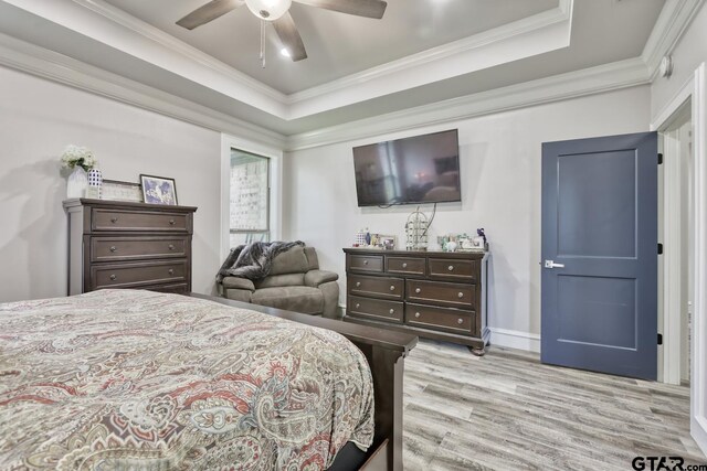 113 Stuart St, Arp, TX 75750 - bedroom featuring light wood finished floors, crown molding, a ceiling fan, and a raised ceiling
