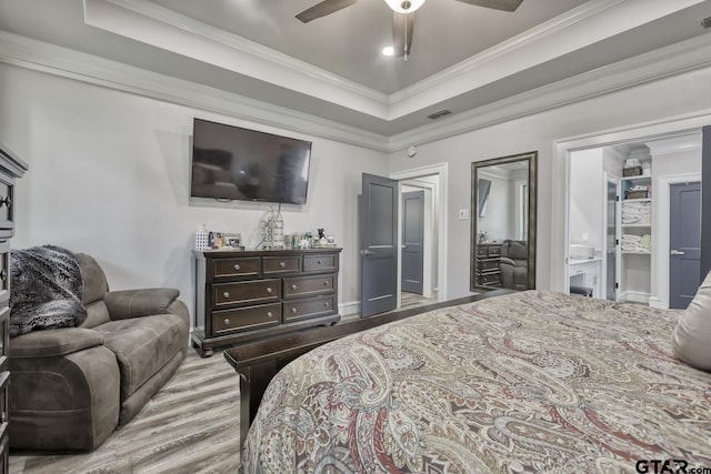 113 Stuart St, Arp, TX 75750 - bedroom with crown molding, wood finished floors, a tray ceiling, and a ceiling fan