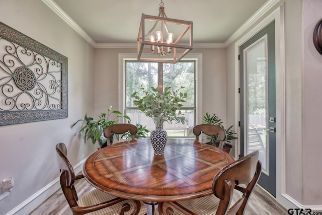 113 Stuart St, Arp, TX 75750 - dining space with light wood-style flooring, a chandelier, and crown molding