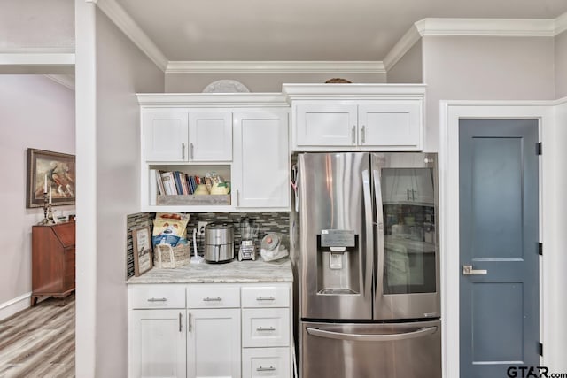 113 Stuart St, Arp, TX 75750 - kitchen with stainless steel refrigerator with ice dispenser, ornamental molding, backsplash, white cabinets, and light wood-style flooring