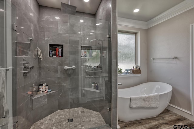 113 Stuart St, Arp, TX 75750 - bathroom featuring ornamental molding, a shower stall, a freestanding tub, and wood finished floors