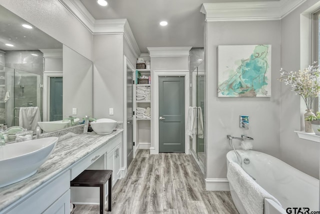 113 Stuart St, Arp, TX 75750 - full bath featuring a shower stall, double vanity, a soaking tub, wood finished floors, and recessed lighting