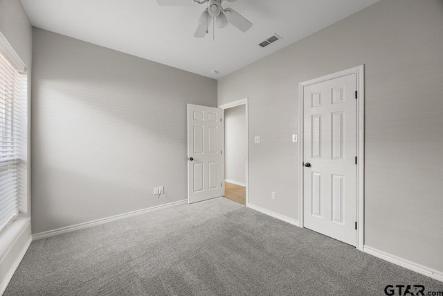 unfurnished bedroom with ceiling fan and carpet floors