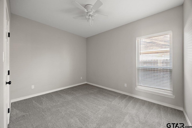 empty room with ceiling fan and carpet