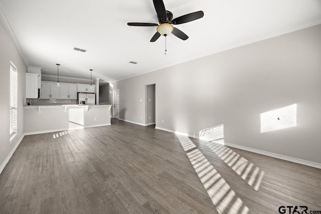 unfurnished living room with dark hardwood / wood-style floors, ceiling fan, and crown molding