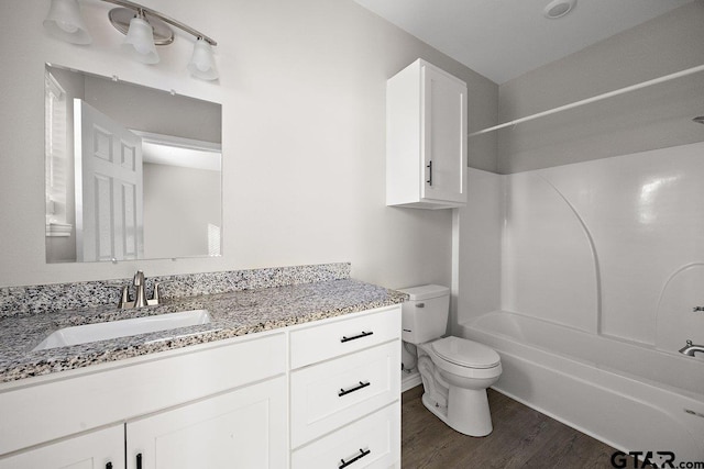 full bathroom with shower / bathing tub combination, vanity, toilet, and wood-type flooring