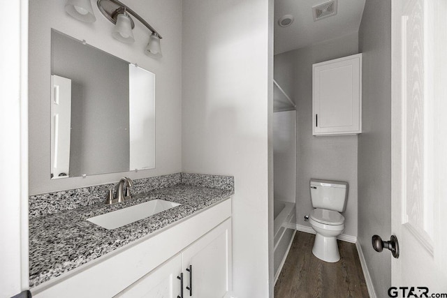 full bathroom with hardwood / wood-style flooring, vanity, toilet, and shower / bathing tub combination