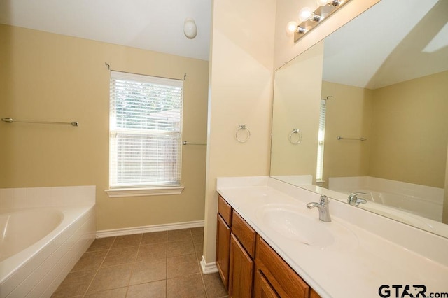 bathroom with vanity, tile patterned floors, and tiled tub