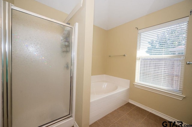 bathroom featuring tile patterned flooring and separate shower and tub