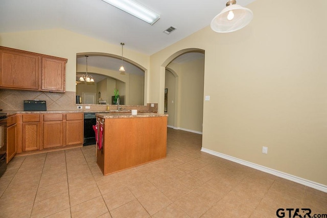 kitchen featuring dishwasher, an inviting chandelier, pendant lighting, lofted ceiling, and a kitchen island