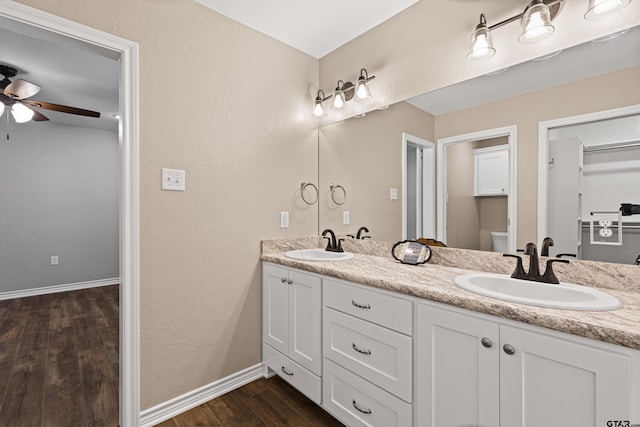 bathroom featuring ceiling fan, wood-type flooring, toilet, and vanity