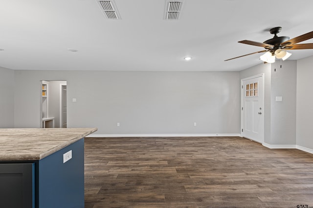 unfurnished living room with ceiling fan and dark hardwood / wood-style floors