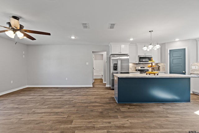 kitchen with stainless steel appliances, white cabinetry, hanging light fixtures, and a center island with sink